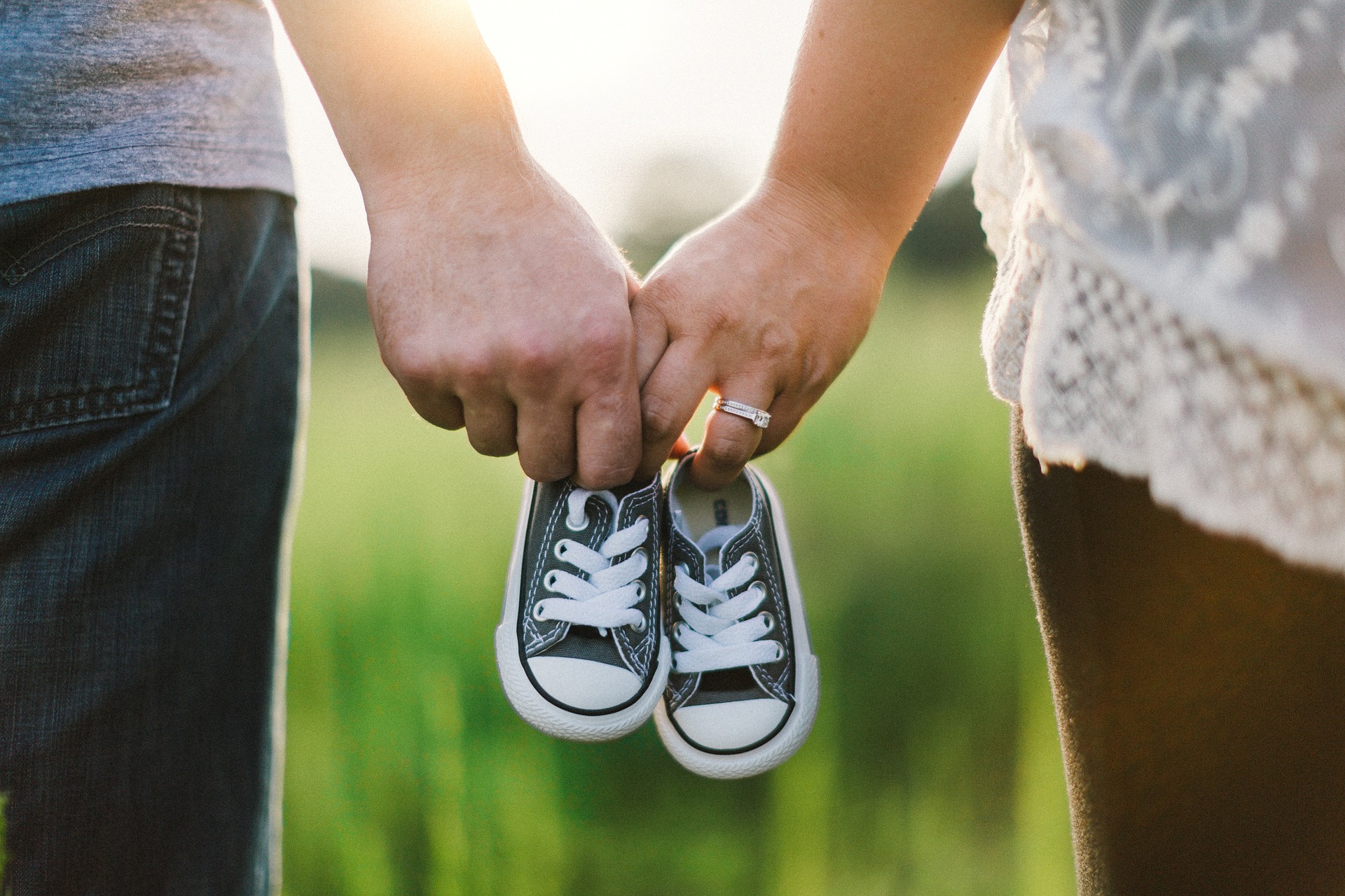 Guardians for a young child hold hands